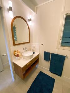 a bathroom with a sink and a mirror at Sanctuary Spaces - Wategoes Beach Shack in Byron Bay +29 photos