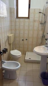 a bathroom with a toilet and a sink at Deda Apartaments in Shëngjin