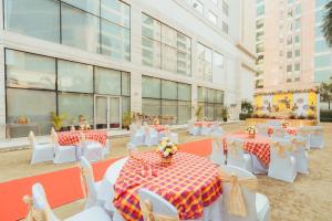 a room with tables and chairs and a building at Fairfield by Marriott Lucknow in Lucknow