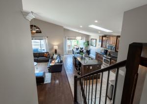 a view of a kitchen and living room at Modern comfort in Lethbridge +25 photos