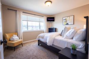 a bedroom with a large bed and a window at Modern comfort in Lethbridge