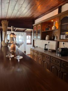 a kitchen with two wine glasses sitting on a counter at Poarta 1 in Portaria