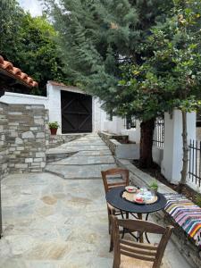 a patio with a table and chairs and a tree at Poarta 1 in Portaria