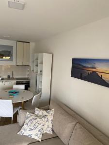 a living room with a couch and a table at Sunrise apartmani in Bar