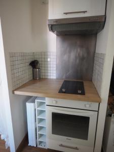 a kitchen with a stove and a counter top at Le Picaflor YourHostHelper in Hyères