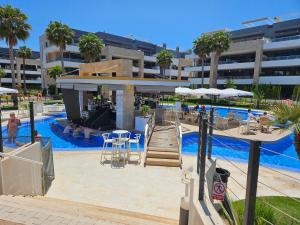 a swimming pool with a slide next to a resort at Flamenca Village Resort apt 455 in Orihuela Costa