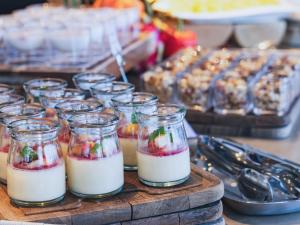 a group of jars filled with milk on a table at Furano Hotel 富良野ホテル in Furano