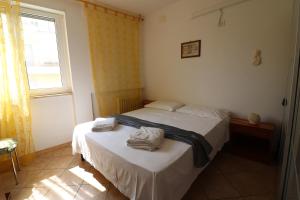 a bedroom with two beds and a window at Ayra's House Otranto in Otranto