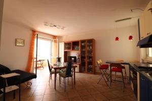 a kitchen and dining room with a table and chairs at Ayra's House Otranto in Otranto