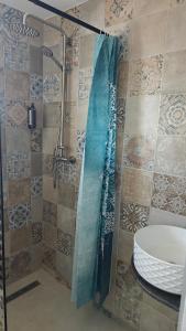 a shower with a glass door next to a sink at Pensiunea Luceafărul, Pasul Mestecăniș in Valea Putnei +88 photos