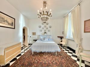 a bedroom with a bed and a chandelier at VILLA NORMA in Levanto