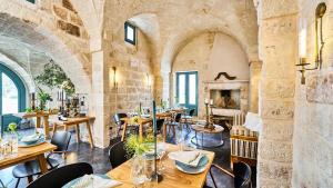 a restaurant with tables and chairs and a fireplace at Bambarone L'Agriturismo in Fasano