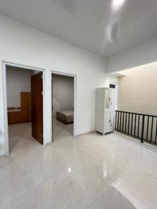 an empty room with a bed and a bedroom at D & R House Syariah in Jagalan