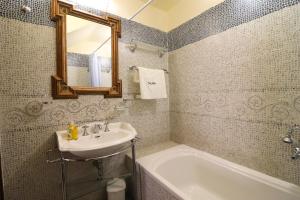 a bathroom with a sink and a tub and a mirror at Dimora Cariddi al Centro Storico in Otranto +18 photos