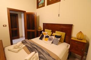 a bedroom with a bed with pillows on it at Dimora Cariddi al Centro Storico in Otranto