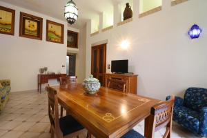 a dining room with a wooden table and chairs at Dimora Cariddi al Centro Storico in Otranto