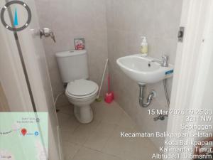 a small bathroom with a toilet and a sink at Villa IDR Grandcity in Balikpapan