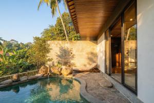 a swimming pool in the backyard of a house at SHIBUMI - Private Pool & Spa Boutique Villa in Ubud
