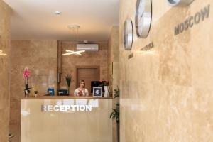 a woman sitting at a reception desk in an office at Sutomore Akapulco Hotel in Sutomore +30 photos