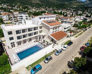 an aerial view of a large white building with a swimming pool at Sutomore Akapulco Hotel in Sutomore
