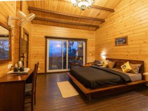 a bedroom with a bed and a desk in a room at The Hosteller Kasar Devi in Almora +18 photos