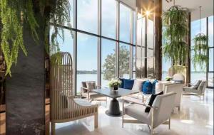 a living room with a table and chairs at ริเวอร์วิวแม่น้ำเจ้าพระยา62ชั้น in Ban Sai Ma