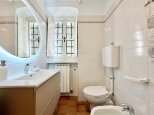 a bathroom with a toilet and a sink and a mirror at VILLA NORMA in Levanto +39 photos
