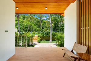 an open door to a porch with a view of trees at Siva Pool Villa in Chaloklum