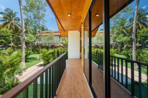 an external view of a house with a balcony at Siva Pool Villa in Chaloklum +32 photos