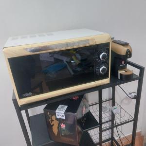 a microwave sitting on top of a shelf at Chiaro di Luna in Crispiano