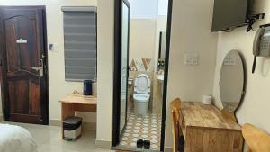 a small bathroom with a toilet and a sink at K Bình Phương Hotel in Da Lat