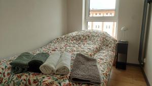 a bed with towels on it with a window at MagMar Studio Kluczbork Rynek Premium in Kluczbork
