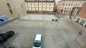 a white van parked in a parking lot in a city at MagMar Studio Kluczbork Rynek Premium in Kluczbork