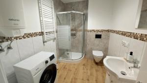 a bathroom with a shower and a toilet and a sink at MagMar Studio Kluczbork Rynek Premium in Kluczbork +16 photos