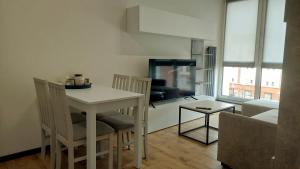 a small kitchen and living room with a table and chairs at MagMar Studio Kluczbork Rynek Premium in Kluczbork