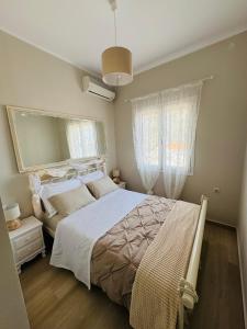 a bedroom with a large bed and a mirror at Kayani View in Taxiárkhai