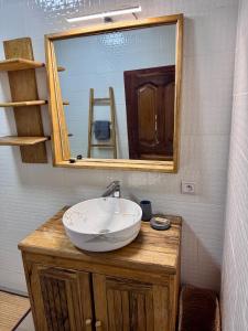 a bathroom with a sink and a mirror at Le Jardin du Saloum in Toubakouta +48 photos