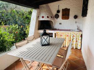 a table and chairs on a patio with a kitchen at Ventus Auster in Olbia