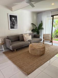 a living room with a couch and a table at Nautilus Noosa Resort in Noosaville