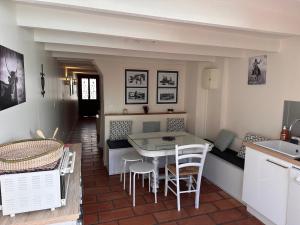 a kitchen and dining room with a table and chairs at La Saline in Aigues-Mortes