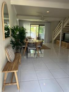 a living room with a table and chairs at Nautilus Noosa Resort in Noosaville