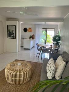 a living room with a couch and a table at Nautilus Noosa Resort in Noosaville