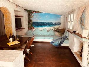 a living room with a couch and a painting of the ocean at Ventus Auster in Olbia