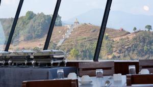 a dining room with a view of a mountain at Pokhara Heights Resort Pvt Ltd in Pokhara