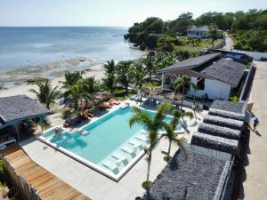 an overhead view of a swimming pool and the beach at SIQUIJOR - THE SEANDYOU Resort in San Juan