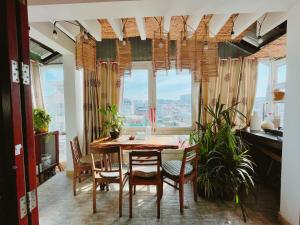a dining room with a table and chairs and a window at Làng Kò Hơ hotel in Da Lat
