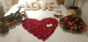 a heart made out of flowers on a bed at Làng Kò Hơ hotel in Da Lat +16 photos