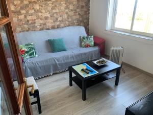 a living room with a couch and a coffee table at A Marosa playa in Burela de Cabo