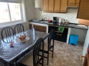 a kitchen with a table with a bowl of fruit on it at A Marosa playa in Burela de Cabo