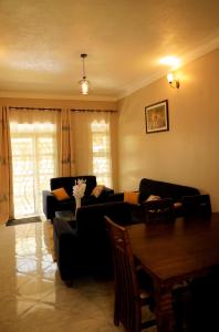 a living room with a couch and a table at Two-bedroom unit in Mubende Town in Mubende
